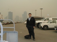 Your photographer, viewed looking east toward downtown San Diego from the Broadway Pier.  ( 1pm to 2 pm 27 Oct 2003)